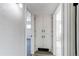 Bright hallway featuring a linen closet with white doors and modern hardware, complemented by warm neutral walls at 9280 Russell Way, Thornton, CO 80229