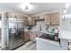 Updated kitchen with stainless steel appliances, light cabinets, and sleek countertops at 9280 Russell Way, Thornton, CO 80229
