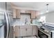 Well-lit kitchen boasts stainless steel appliances, bright countertops, and modern fixtures at 9280 Russell Way, Thornton, CO 80229