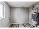 Bright laundry area includes new water heater and gray wood-look flooring at 9280 Russell Way, Thornton, CO 80229