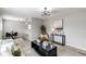 Open concept living room with lots of plants and neutral colored furniture at 9280 Russell Way, Thornton, CO 80229