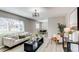 Bright living room with lots of plants and neutral colored furniture at 9280 Russell Way, Thornton, CO 80229