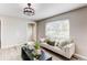 Bright living room with neutral colored furniture and view of front yard at 9280 Russell Way, Thornton, CO 80229