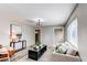 Well-lit living room with neutral colored furniture and open floor plan at 9280 Russell Way, Thornton, CO 80229