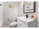 Clean bathroom featuring a modern vanity, toilet, decorative mirror, and a shower/tub combo at 2810 Cherry St, Denver, CO 80207