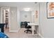 Bedroom featuring a desk, office chair, a crib, and a walk-in closet with organized storage at 2810 Cherry St, Denver, CO 80207