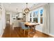 Bright dining area with a wooden table, modern lighting, and large windows looking out to the neighborhood at 2810 Cherry St, Denver, CO 80207