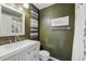 Simple bathroom with a shower/tub combo and muted green walls at 6324 S Grape Ct, Centennial, CO 80121