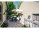 Deck with outdoor dining set, umbrella, and gray patterned rug at 6324 S Grape Ct, Centennial, CO 80121