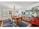 Bright dining room with a wooden table, chandelier and kitchen bar at 6324 S Grape Ct, Centennial, CO 80121