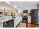 Modern kitchen featuring stainless steel appliances and white cabinetry at 6324 S Grape Ct, Centennial, CO 80121