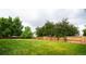 Large, well-maintained backyard with lush green grass and mature trees, offering privacy and space at 4760 S Wright Way, Morrison, CO 80465