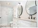 Bright bathroom featuring double sinks, granite countertops, and a sleek glass-enclosed shower at 4760 S Wright Way, Morrison, CO 80465