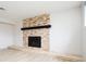 Modern fireplace with stone surround and a sleek black mantel at 4760 S Wright Way, Morrison, CO 80465