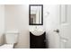 Stylish half-bathroom features a modern vanity, mirror, and fixtures at 4760 S Wright Way, Morrison, CO 80465