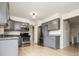 Modern kitchen featuring gray cabinets, stainless steel appliances and hardwood floors at 4760 S Wright Way, Morrison, CO 80465