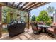 Comfortable back deck boasts a grill, patio furniture, and a covered pergola, offering a relaxing outdoor space at 20182 E Maplewood Pl, Centennial, CO 80016