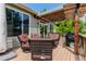 Relaxing back deck with a pergola, patio furniture, and a grill, perfect for outdoor entertaining at 20182 E Maplewood Pl, Centennial, CO 80016