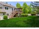 Large backyard featuring a deck, grassy area, and mature trees at 20182 E Maplewood Pl, Centennial, CO 80016
