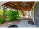 Backyard covered patio with hanging lights, landscaping and a decorative chair at 20182 E Maplewood Pl, Centennial, CO 80016