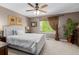 Relaxing bedroom featuring a tufted headboard, a ceiling fan, and a window with natural lighting at 20182 E Maplewood Pl, Centennial, CO 80016