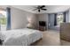 Modern bedroom with a TV, ceiling fan and neutral decor at 20182 E Maplewood Pl, Centennial, CO 80016