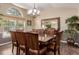 Spacious dining room with a large wooden table, seating for eight, chandelier and a large window at 20182 E Maplewood Pl, Centennial, CO 80016