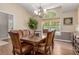 Elegant dining room with a large wooden table, seating for eight, and a beautiful chandelier at 20182 E Maplewood Pl, Centennial, CO 80016