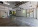 Spacious two car garage with concrete floors, overhead lighting, built-in shelving and windows for natural light at 20182 E Maplewood Pl, Centennial, CO 80016