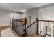 Hallway with hardwood floors featuring wood and wrought iron railings at 20182 E Maplewood Pl, Centennial, CO 80016