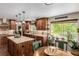 Bright kitchen with wood cabinetry, granite countertops, and a view of the backyard at 20182 E Maplewood Pl, Centennial, CO 80016