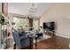 Cozy living room with ample natural light, hardwood floors, and comfortable seating arrangement at 20182 E Maplewood Pl, Centennial, CO 80016