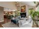 Comfortable living room with fireplace open to kitchen with hardwood floors and many windows at 20182 E Maplewood Pl, Centennial, CO 80016