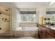 Bright main bathroom featuring a glass block shower, soaking tub, and vanity at 20182 E Maplewood Pl, Centennial, CO 80016
