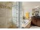 Luxurious main bathroom features a glass block shower and a soaking tub at 20182 E Maplewood Pl, Centennial, CO 80016