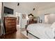 Large main bedroom boasts wood floors, a TV, and access to a main bathroom at 20182 E Maplewood Pl, Centennial, CO 80016