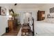 Spacious main bedroom features a ceiling fan, wood floors, and French doors to the main bathroom at 20182 E Maplewood Pl, Centennial, CO 80016