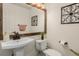 Bright powder room featuring stylish fixtures, a pedestal sink, and decorative wall accents at 20182 E Maplewood Pl, Centennial, CO 80016