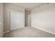 Spacious carpeted bedroom with closet and white trim at 8421 Galvani Trl # E, Littleton, CO 80129