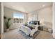 Comfortable bedroom with large window, carpet, and tasteful decor at 8421 Galvani Trl # E, Littleton, CO 80129