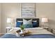 Cozy bedroom featuring a decorative arrangement on the bed and stylish bedside tables at 8421 Galvani Trl # E, Littleton, CO 80129