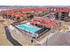An aerial photograph displaying the community pool area, complete with lounge chairs and shaded structures at 8421 Galvani Trl # E, Littleton, CO 80129