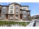 Inviting townhome featuring a beautiful stone facade, private entry, and well-maintained landscaping at 8421 Galvani Trl # E, Littleton, CO 80129