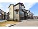 Modern townhome exterior with stone accents and attached garages, enhanced curb appeal at 8421 Galvani Trl # E, Littleton, CO 80129