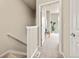 Upstairs hallway view leading to a bedroom with neutral tones and carpeted floor at 8421 Galvani Trl # E, Littleton, CO 80129