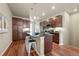 Modern kitchen with a granite island, dark wood cabinets, and stainless steel appliances at 8421 Galvani Trl # E, Littleton, CO 80129
