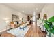 Spacious living room featuring modern decor and wood flooring throughout at 8421 Galvani Trl # E, Littleton, CO 80129
