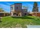 Expansive backyard featuring a well-maintained lawn, modern home architecture, and an inviting outdoor space at 1220 S Elm St, Denver, CO 80246