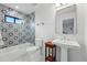 Updated bathroom with stylish vanity, glassed in shower, and decorative tile at 1220 S Elm St, Denver, CO 80246