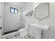 Modern bathroom featuring glass shower, tiled floor, stylish mirror, sink, and toilet at 1220 S Elm St, Denver, CO 80246